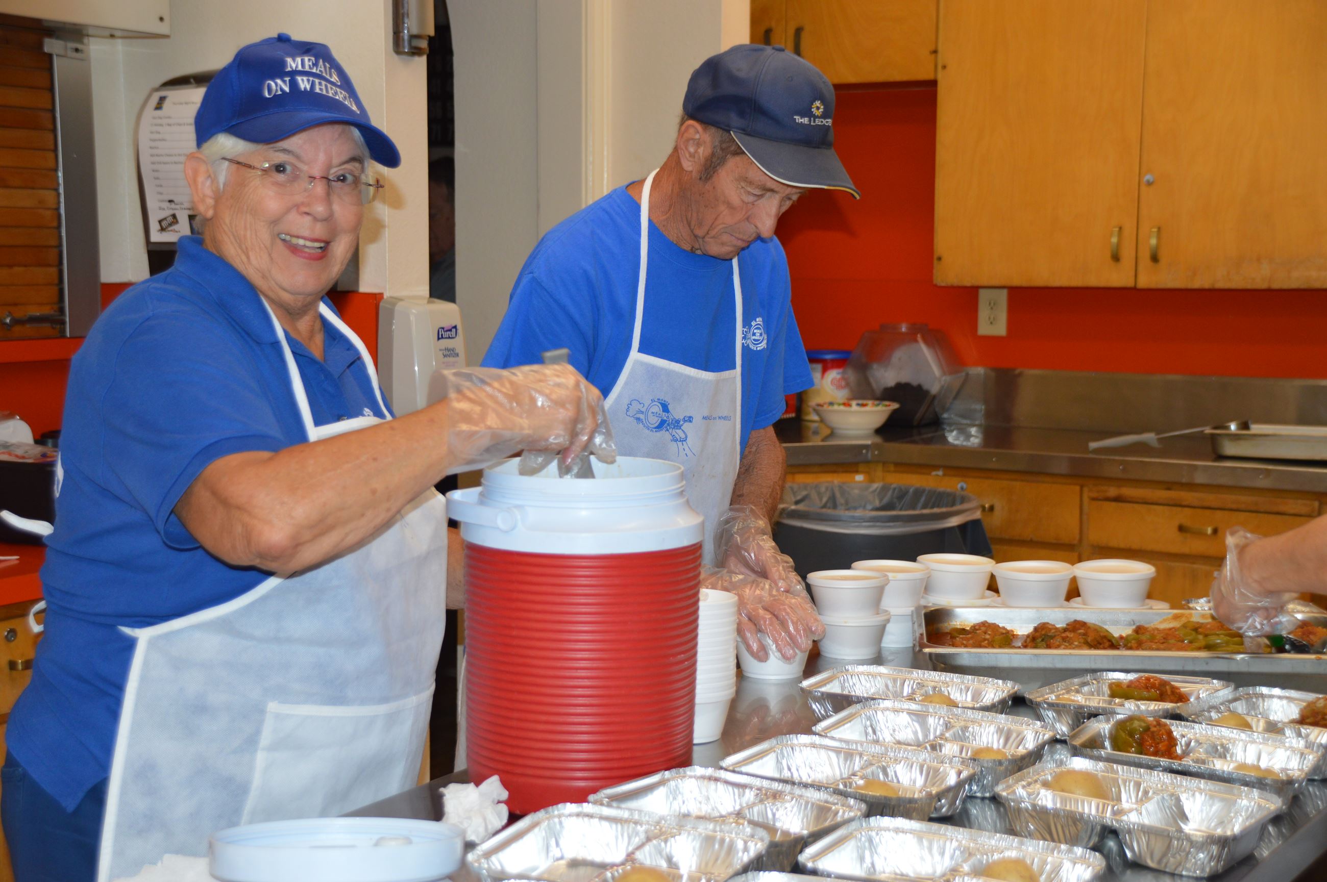 Meals on Wheels volunteers packing meals for the homebound